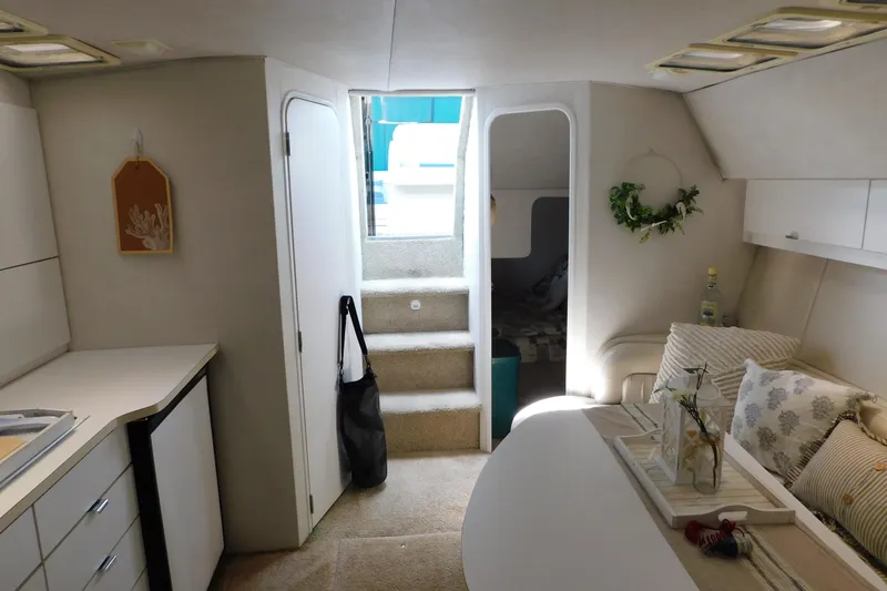 Slide: The Image of Interior of a 1993 Silverton 34 Express boat, featuring cozy seating and modern decor. - 58