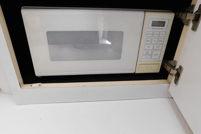 Slide: The Image of Built-in Kenmore microwave in a 1993 Silverton 34 Express boat kitchen cabinet. - 36
