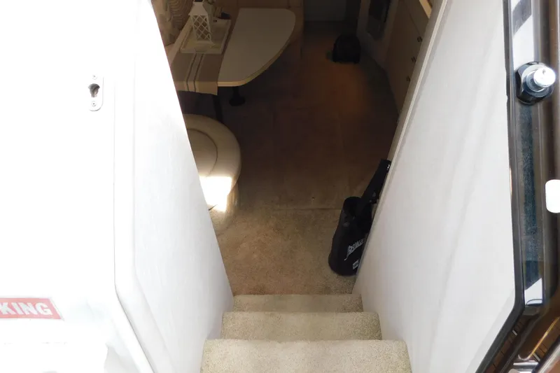 Slide: The Image of Interior view of 1993 Silverton 34 Express yacht, showing stairs and cabin area. - 29