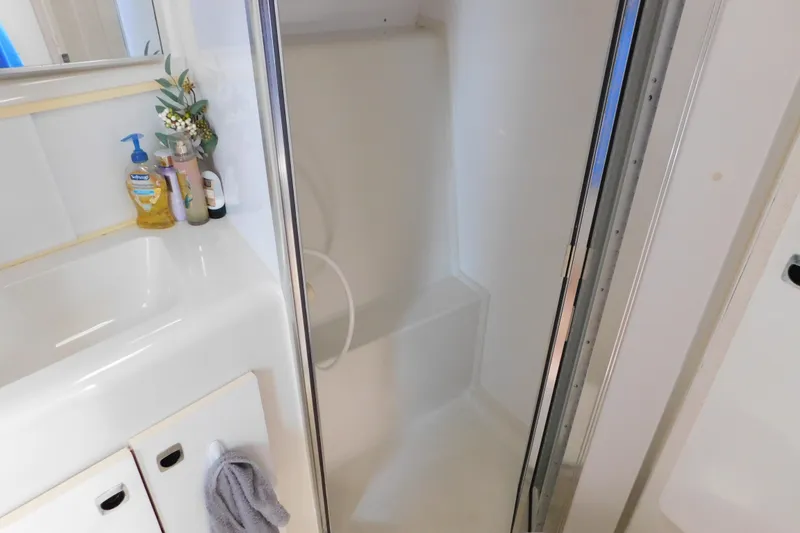 Slide: The Image of Bathroom interior of 1993 Silverton 34 Express yacht with shower and sink. - 68
