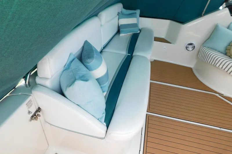 Slide: The Image of Interior of 1993 Silverton 34 Express yacht with cushioned seating and decorative pillows. - 10