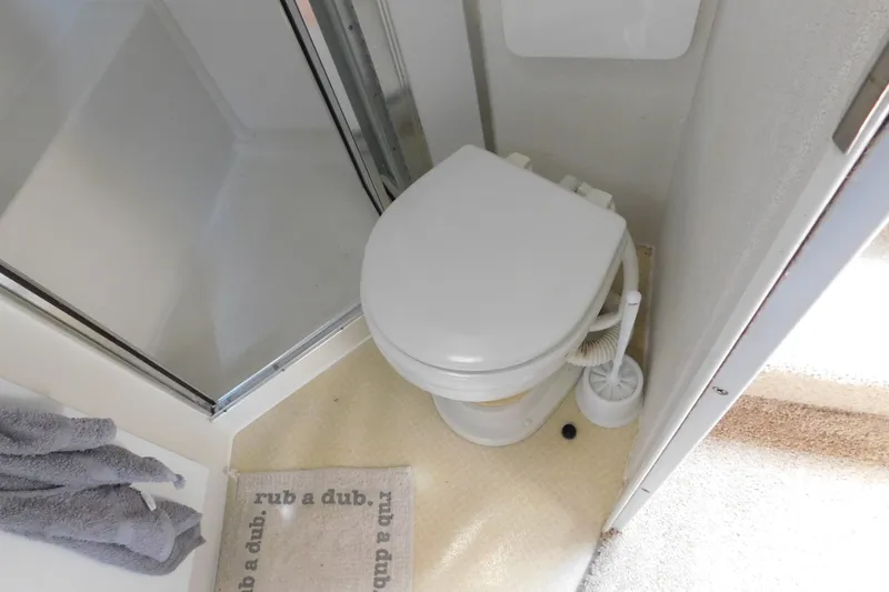 Slide: The Image of Bathroom in 1993 Silverton 34 Express boat with toilet and shower area. - 70