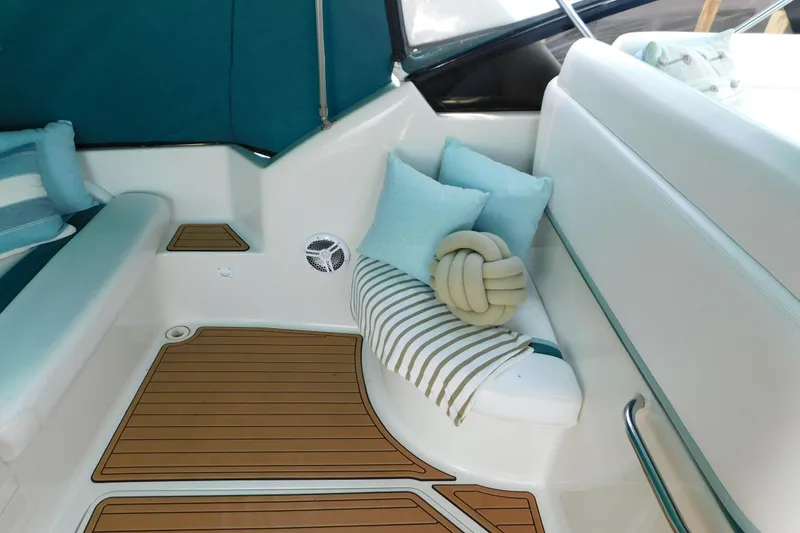 Slide: The Image of Interior of 1993 Silverton 34 Express boat with cushions and striped decor. - 13