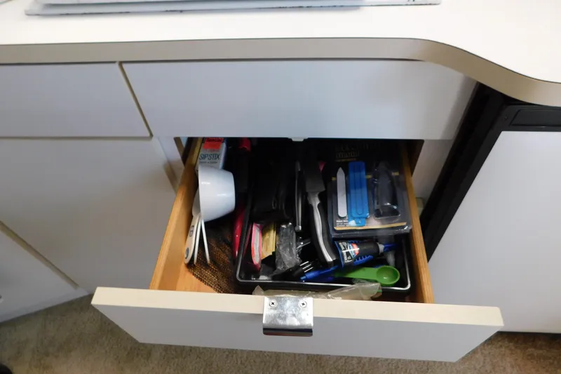 Slide: The Image of Open drawer with assorted kitchen utensils and tools on a Silverton 34 Express, 1993 model. - 47