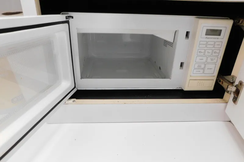 Slide: The Image of Open microwave oven inside a Silverton 34 Express, 1993 model. - 37