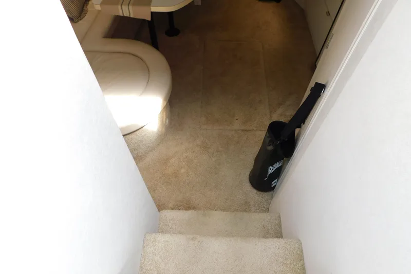 Slide: The Image of Interior view of 1993 Silverton 34 Express yacht, featuring carpeted stairs and seating area. - 30