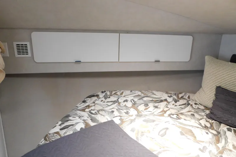 Slide: The Image of Interior cabin of 1993 Silverton 34 Express with floral bedding and storage compartments. - 53