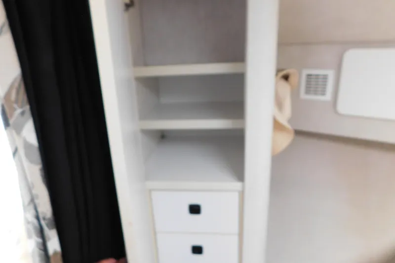 Slide: The Image of Interior storage shelves and drawers in a 1993 Silverton 34 Express boat. - 55