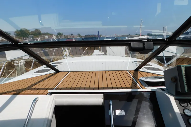 Slide: The Image of 1993 Silverton 34 Express yacht interior with wooden deck and clear glass canopy. - 28