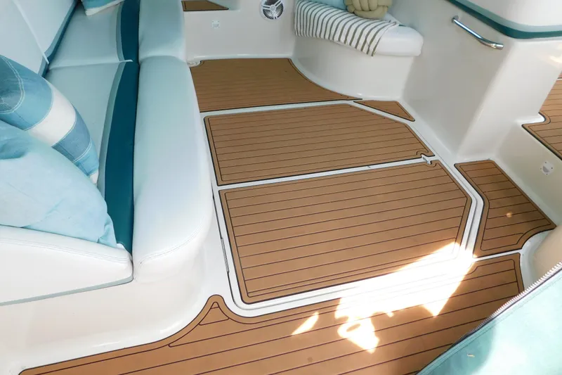Slide: The Image of Interior of 1993 Silverton 34 Express boat with cushioned seating and teak-style flooring. - 11