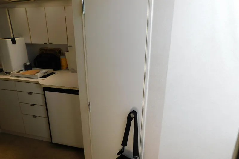 Slide: The Image of Interior of 1993 Silverton 34 Express boat, featuring compact kitchen area. - 65