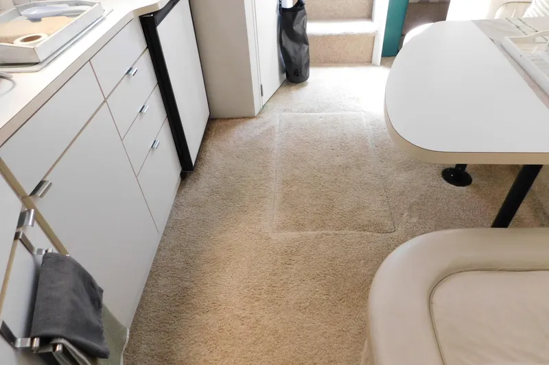 Slide: The Image of Interior of a 1993 Silverton 34 Express yacht with carpeted flooring and kitchenette. - 56