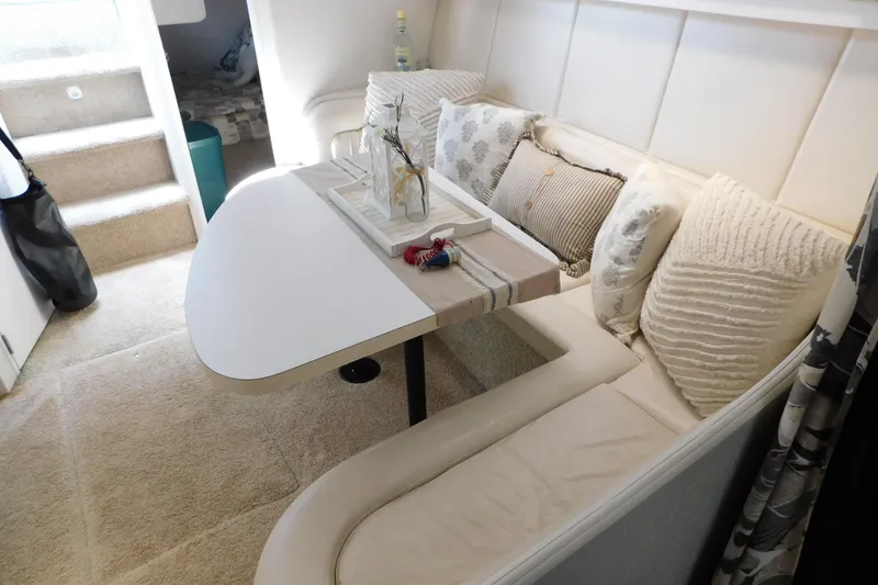 Slide: The Image of Interior of 1993 Silverton 34 Express yacht with cozy seating and decorative pillows. - 57