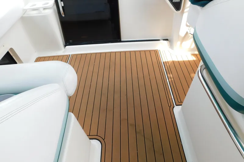 Slide: The Image of Interior of a 1993 Silverton 34 Express boat with teak flooring and white seating. - 25