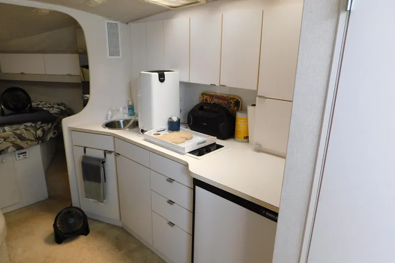 Slide: The Image of 1993 Silverton 34 Express yacht interior kitchen with modern amenities and compact design. - 31