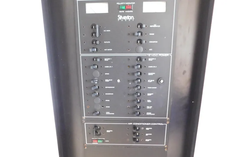 Slide: The Image of Control panel of a 1993 Silverton 34 Express yacht, featuring various switches and indicators. - 41