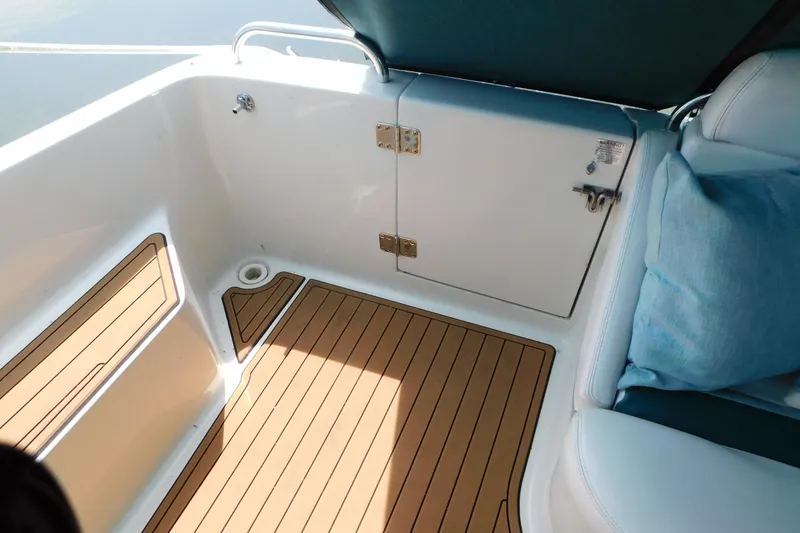 Slide: The Image of 1993 Silverton 34 Express boat interior with cushioned seating and wooden flooring. - 27