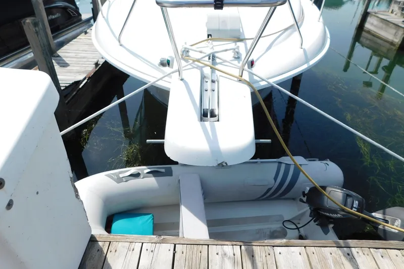 Slide: The Image of 1993 Silverton 34 Express yacht docked with inflatable boat attached. - 3