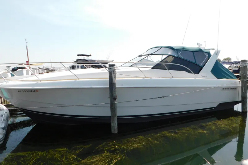 Slide: The Image of 1993 Silverton 34 Express boat docked at marina, side view. - 2