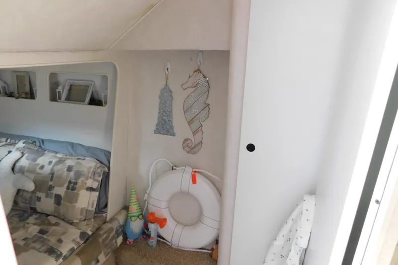 Slide: The Image of Interior of 1993 Silverton 34 Express boat with nautical decor and cozy seating area. - 61