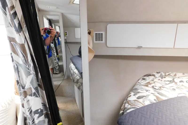 Slide: The Image of Interior of 1993 Silverton 34 Express boat with floral bedding and mirrored closet. - 54
