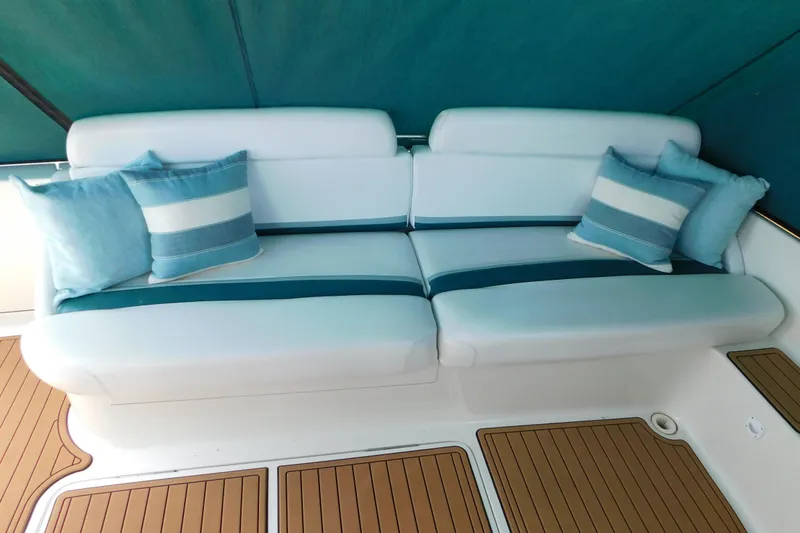 Slide: The Image of Luxurious seating on 1993 Silverton 34 Express boat with striped cushions and teak flooring. - 12