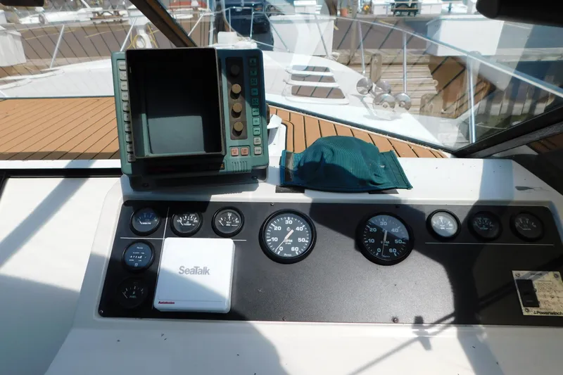 Slide: The Image of 1993 Silverton 34 Express dashboard with gauges, navigation equipment, and SeaTalk system. - 21