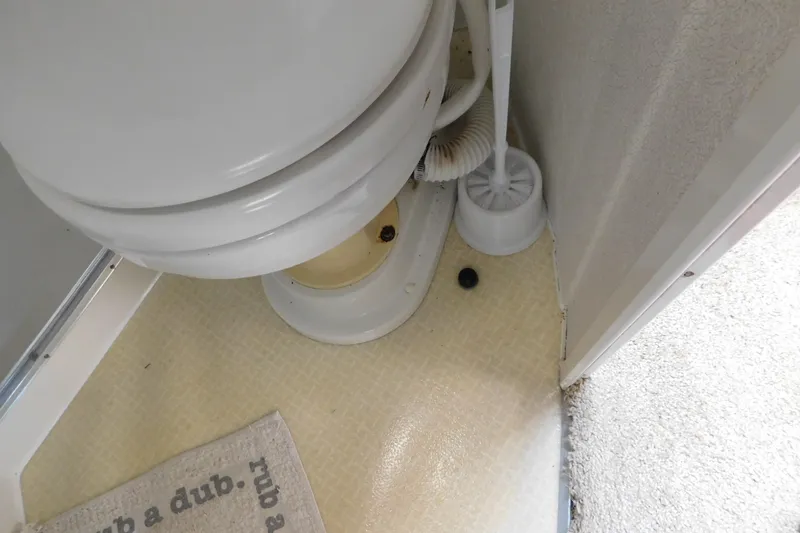 Slide: The Image of Boat bathroom with toilet and cleaning brush, Silverton 34 Express, 1993 model. - 71