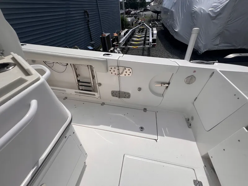 Slide: The Image of The image shows the cockpit of a 2021 Edgewater 262CC boat with a clean, white design. - 14