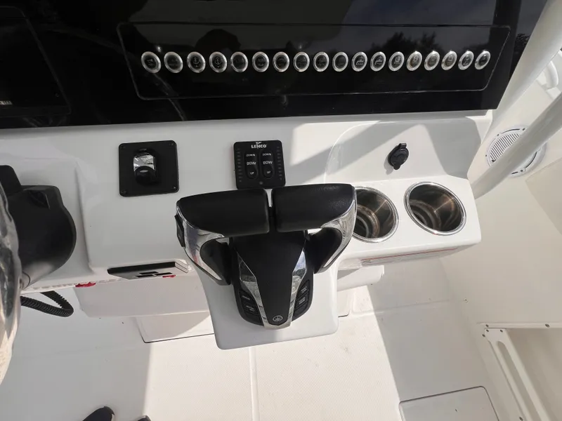 Slide: The Image of The image shows the helm of an Edgewater 262CC boat with modern controls and cup holders. - 23