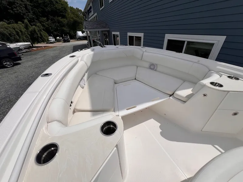 Slide: The Image of The image shows the spacious bow area of an Edgewater 262CC boat with white upholstery. - 35