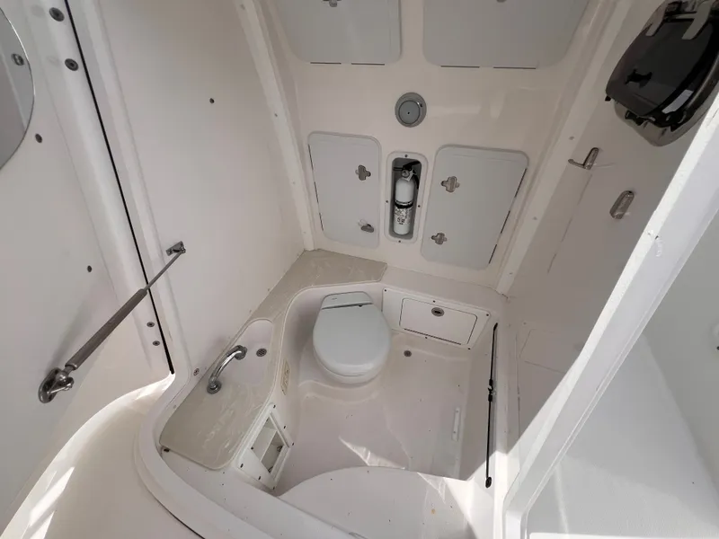 Slide: The Image of The image shows a boat bathroom interior with a toilet and multiple storage compartments. - 37