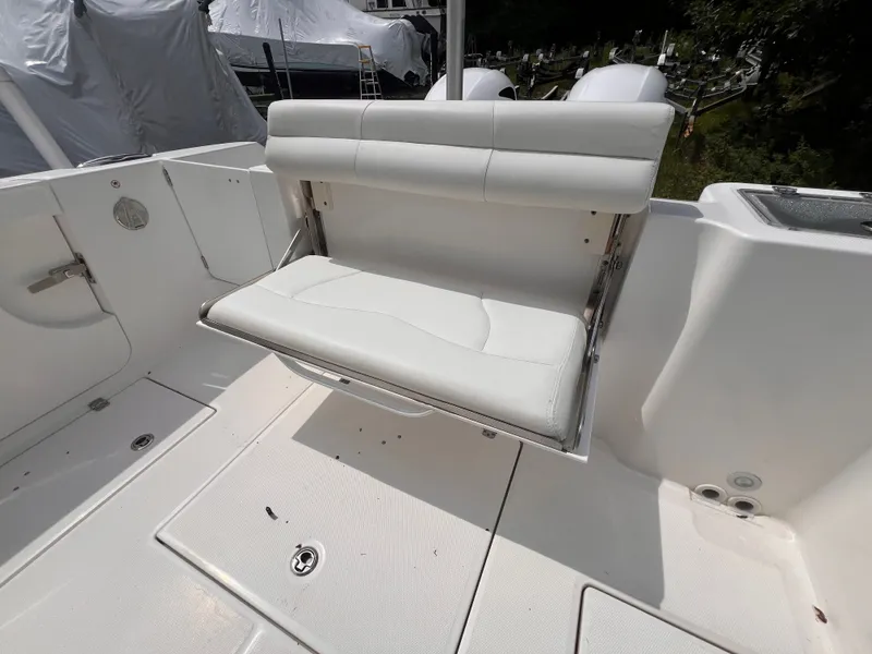 Slide: The Image of The image shows a white, foldable bench seat on a boat, surrounded by a clean deck area. - 17