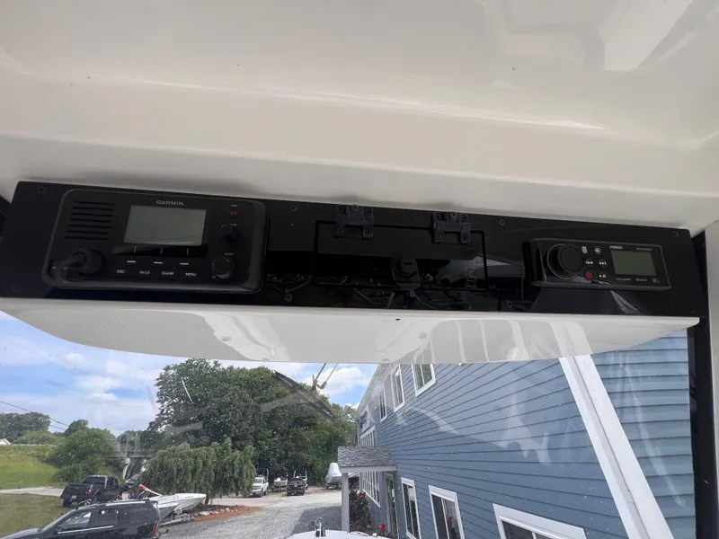 Slide: The Image of The image shows the dashboard of an Edgewater 262CC boat with electronic devices. - 24