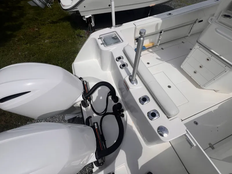 Slide: The Image of The image shows the stern of an Edgewater 262CC boat with twin outboard engines and a bench seat. - 10