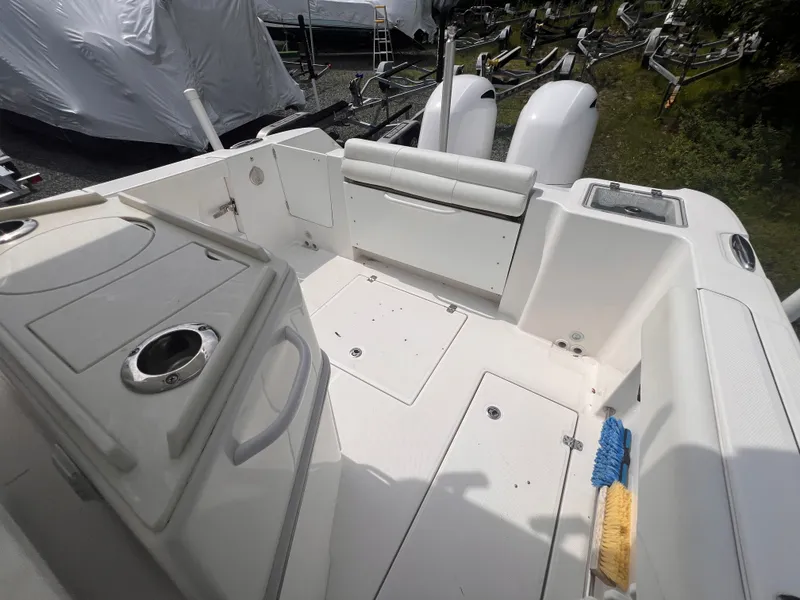 Slide: The Image of The image shows the cockpit of a 2021 Edgewater 262CC boat with a clean, white interior. - 16