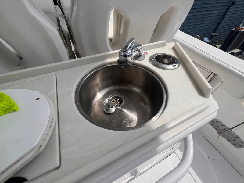 Slide: The Image of A stainless steel sink with a faucet on a boat, surrounded by white surfaces. - 13