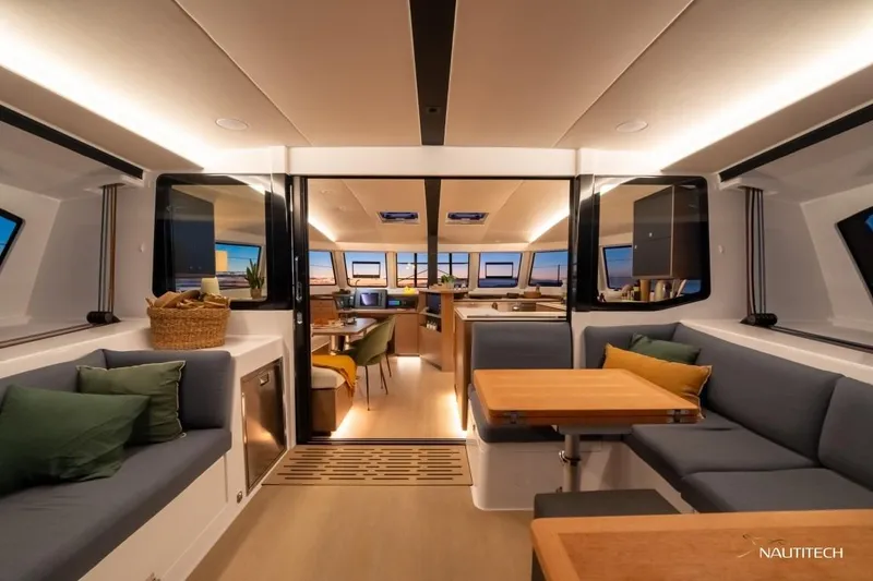 Slide: The Image of Interior of a modern yacht with stylish seating areas and a dining table. - 19