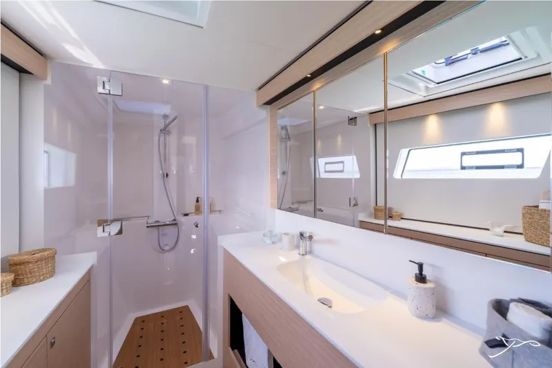 Slide: The Image of Modern bathroom with shower, sink, and mirrors in a 2027 Nautitech 44 Open. - 32