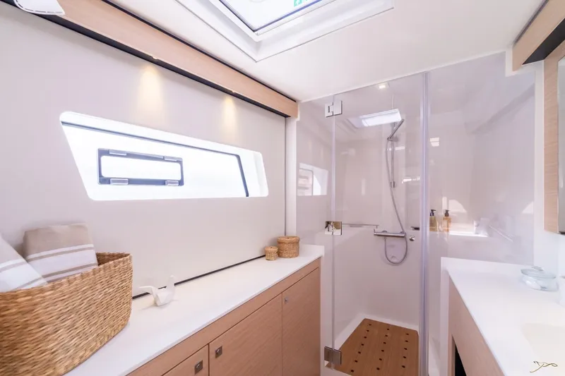 Slide: The Image of Modern bathroom with shower, wood accents, and natural light from a window. - 33