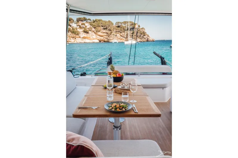 Slide: The Image of A set table on a Nautitech 44 Open catamaran overlooking the sea. - 18
