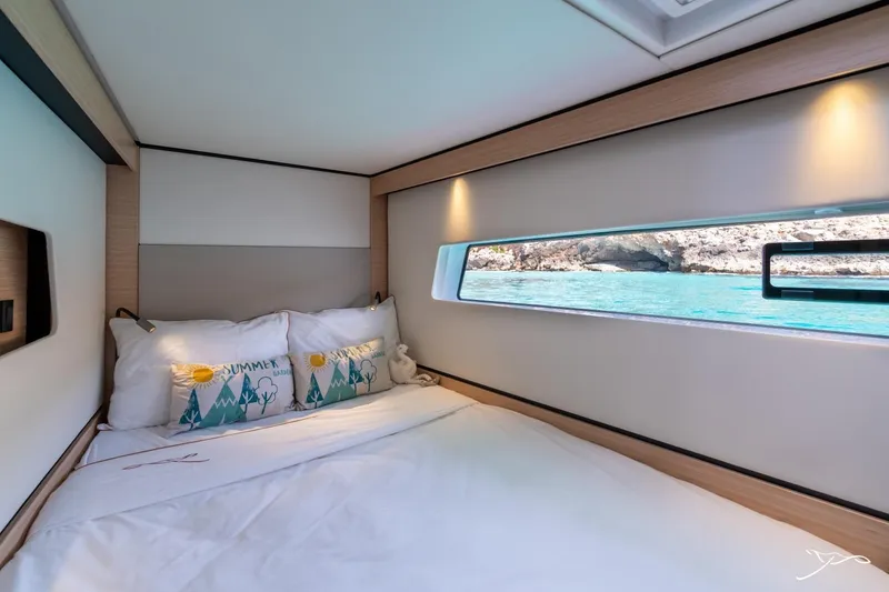 Slide: The Image of The 2027 Nautitech 44 Open cabin features a cozy bed with a view of the sea. - 29