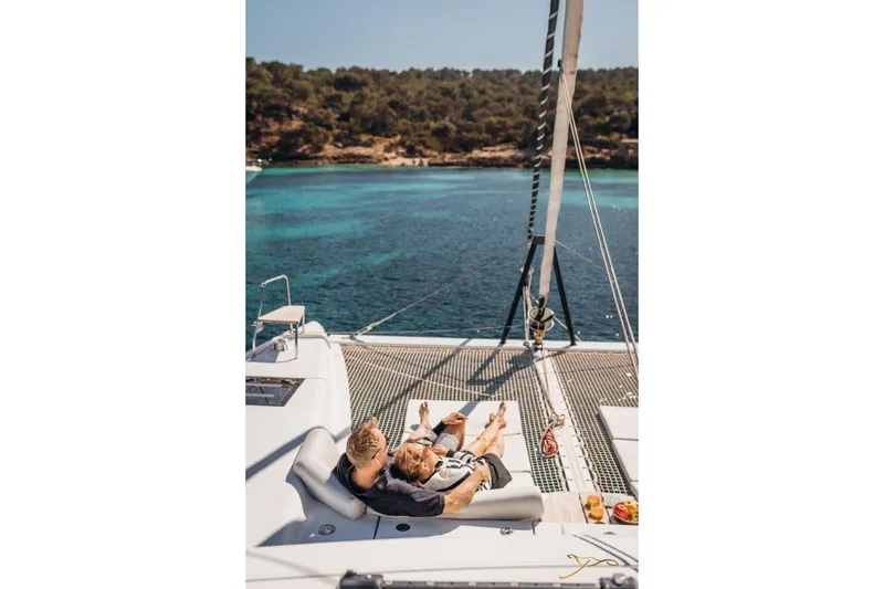 Slide: The Image of A couple relaxes on the deck of a Nautitech 44 Open, overlooking the blue water. - 23