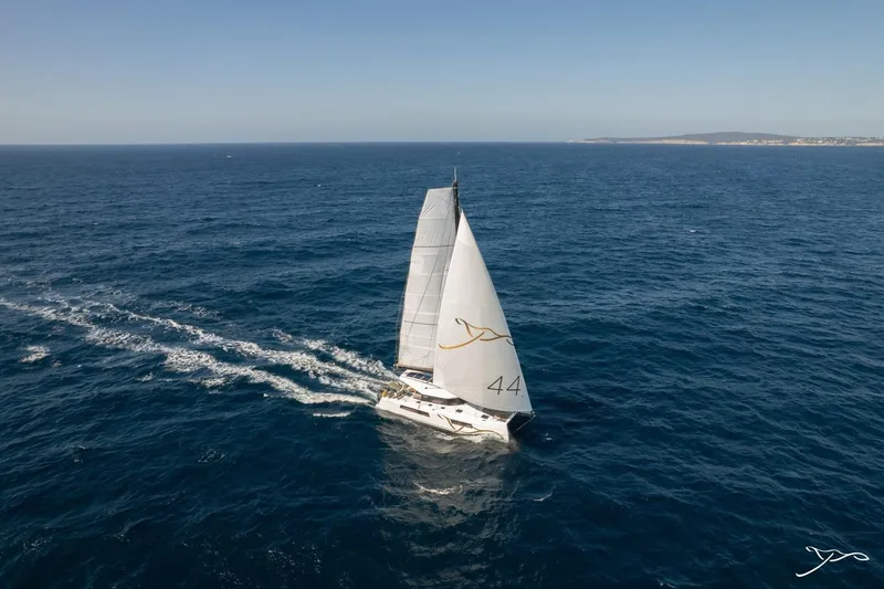 Slide: The Image of The 2027 Nautitech 44 Open sails on open sea under a clear sky. - 10