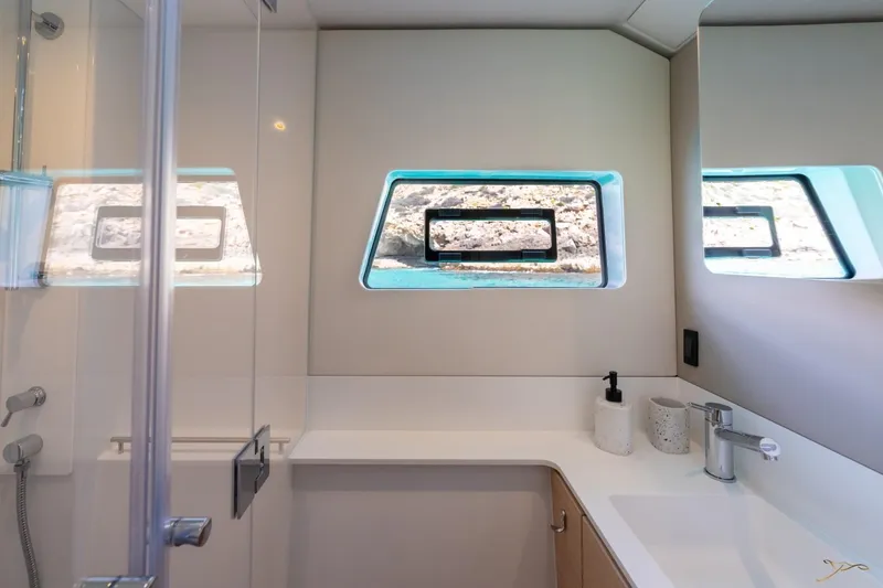 Slide: The Image of Modern bathroom with window, sink, and shower in a Nautitech 44 Open boat. - 31
