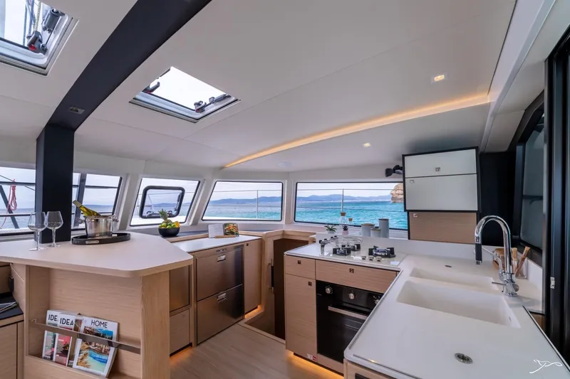 Slide: The Image of Interior view of a modern yacht kitchen with sleek wood and metal elements, overlooking the sea. - 38