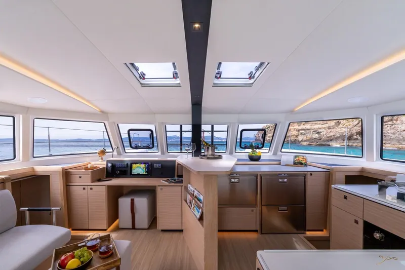 Slide: The Image of The interior of the 2027 Nautitech 44 Open features a modern kitchen with large windows and ocean views. - 49