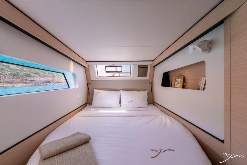 Slide: The Image of The image shows a cozy cabin with a double bed, windows, and wood paneling. - 30