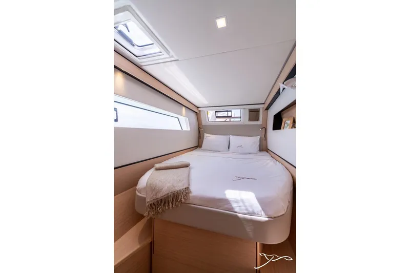 Slide: The Image of The image shows a cozy cabin with a double bed and a side window. - 44