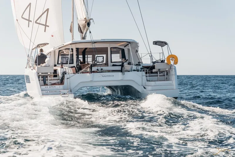 Slide: The Image of A modern sailing catamaran, the Nautitech 44 Open, sails on open waters. The sails are hoisted. - 6